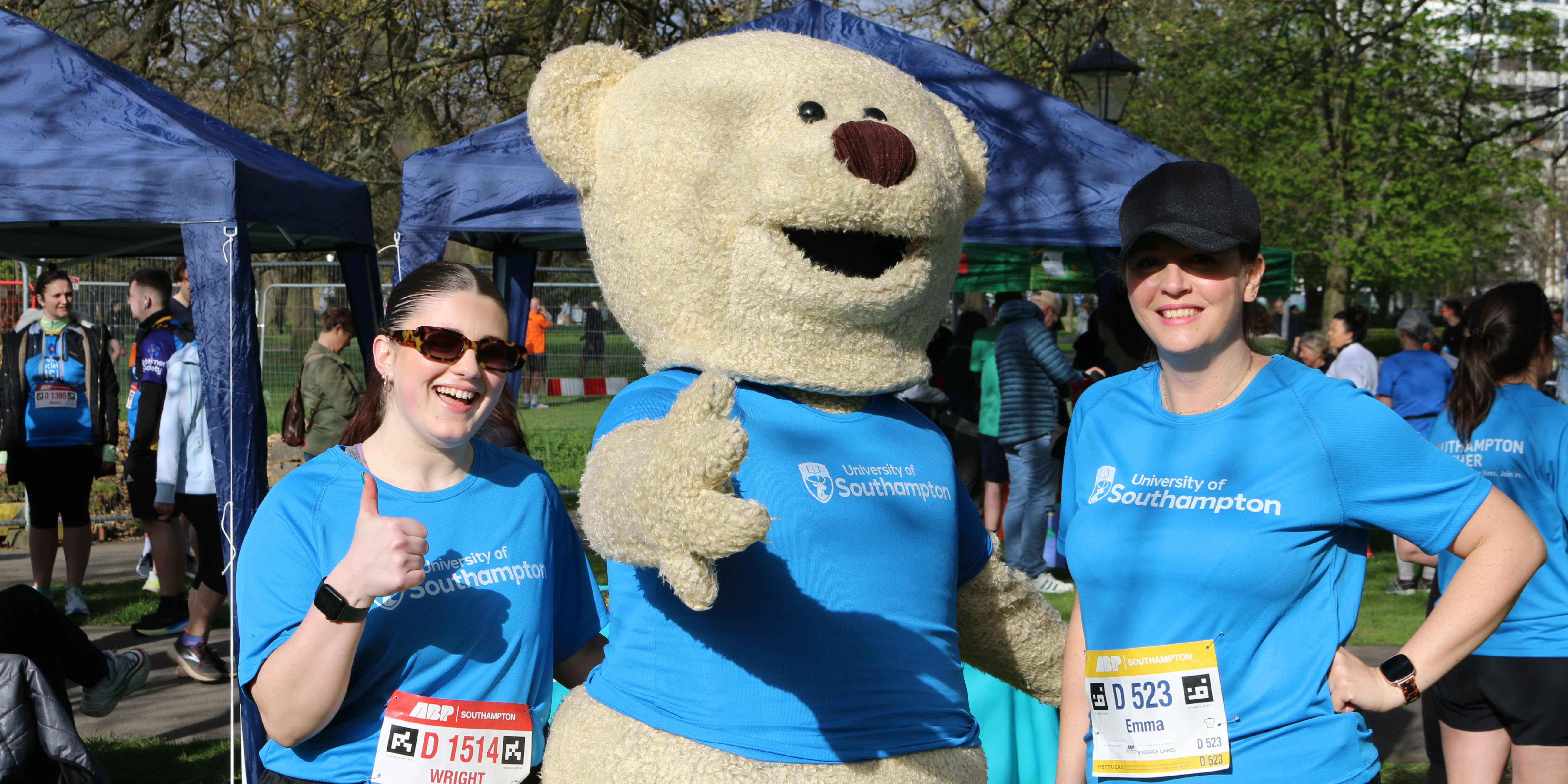 Sophie and Emma posing with Hartly Bear at the 2024 Southampton Marathon