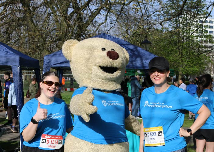 Sophie and Emma posing with Hartly Bear at the 2024 Southampton Marathon